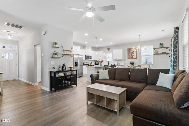 320 Everly Mist Way, Wake Forest, NC 27587 - living room featuring light wood-type flooring, ceiling fan, plenty of natural light, a chandelier, and recessed lighting
