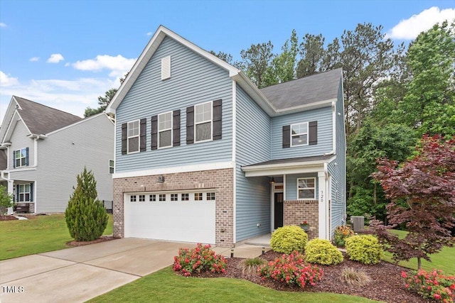 320 Everly Mist Way, Wake Forest, NC 27587 - view of front of house featuring brick siding, an attached garage, concrete driveway, and a front yard
