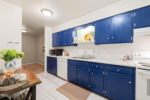 kitchen featuring a sink, white appliances, light countertops, and under cabinet range hood