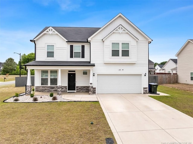 1307 Water Leaf Dr, Fayetteville, NC 28314 - craftsman house featuring board and batten siding, an attached garage, covered porch, concrete driveway, and stone siding