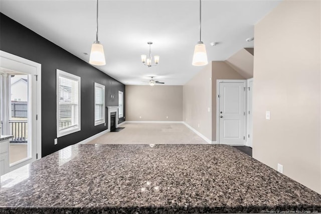 1307 Water Leaf Dr, Fayetteville, NC 28314 - kitchen with a chandelier, ceiling fan, a center island, pendant lighting, and light carpet