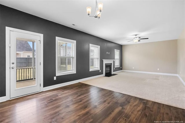 1307 Water Leaf Dr, Fayetteville, NC 28314 - unfurnished living room featuring a chandelier, wood finished floors, baseboards, and a fireplace with flush hearth