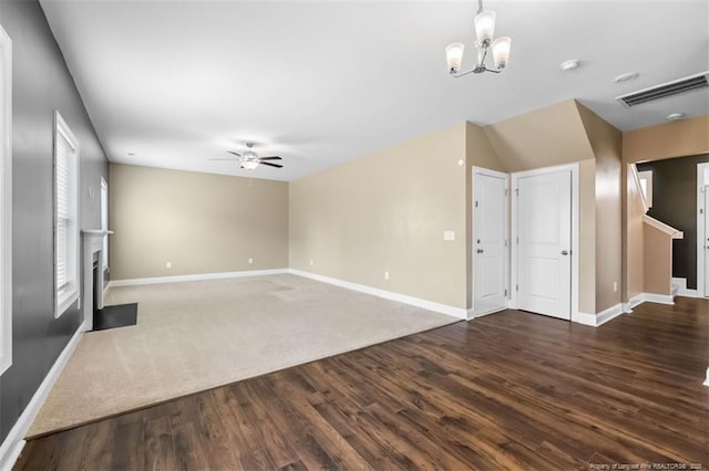 1307 Water Leaf Dr, Fayetteville, NC 28314 - unfurnished living room with wood finished floors, a ceiling fan, baseboards, and a chandelier