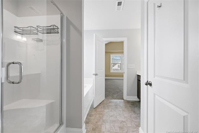 1307 Water Leaf Dr, Fayetteville, NC 28314 - bathroom featuring baseboards, marble finish floors, a stall shower, and a garden tub