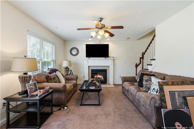 9012 Grouse Run Ln, Fayetteville, NC 28314 - carpeted living room featuring a ceiling fan, a fireplace with flush hearth, and stairs