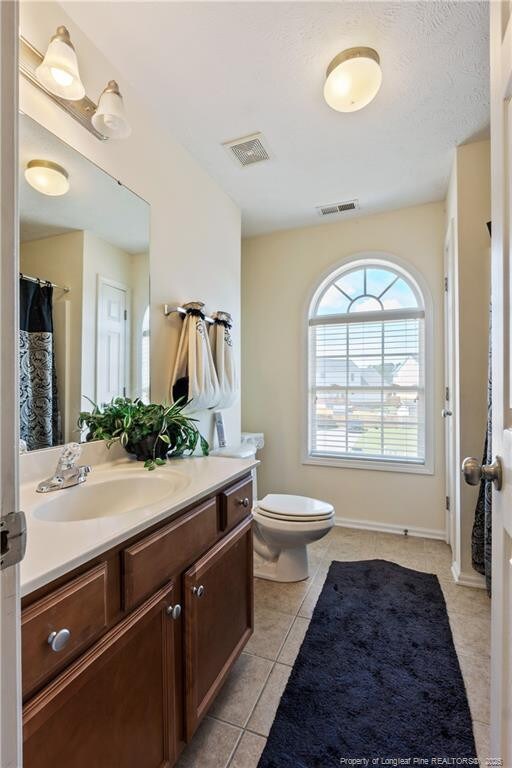 9012 Grouse Run Ln, Fayetteville, NC 28314 - bathroom featuring vanity, tile patterned floors, and toilet