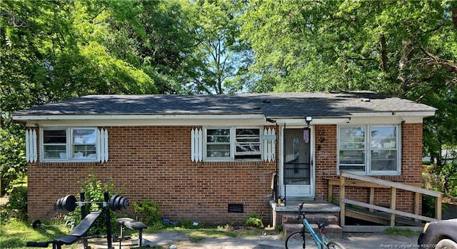 view of front of property featuring brick siding and a shingled roof