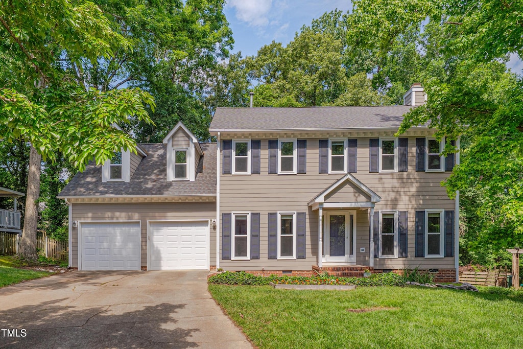 203 N Becket St, Cary, NC 27513 - colonial-style house featuring crawl space, an attached garage, concrete driveway, a chimney, and a shingled roof