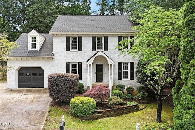 1312 Stonemoor Ct, Raleigh, NC 27606 - colonial house featuring a garage, driveway, and a shingled roof