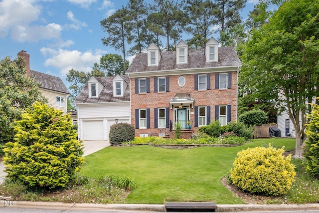 8420 Caldbeck Dr, Raleigh, NC 27615 - colonial-style house with brick siding, a front yard, an attached garage, and driveway