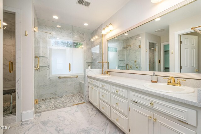 8420 Caldbeck Dr, Raleigh, NC 27615 - bathroom featuring marble look tiles, a stall shower, double vanity, and recessed lighting