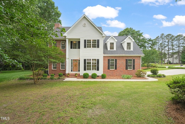 1005 Barmkin Pl, Knightdale, NC 27545 - neoclassical home with brick siding, a front yard, and roof with shingles