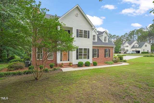 1005 Barmkin Pl, Knightdale, NC 27545 - view of front of property featuring brick siding, a front lawn, and central AC unit