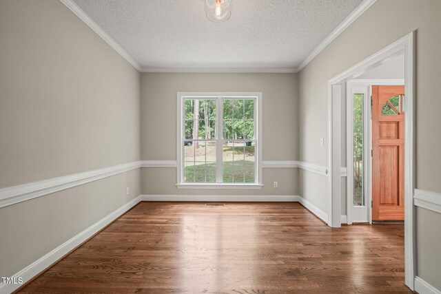 1005 Barmkin Pl, Knightdale, NC 27545 - empty room with a textured ceiling, wood finished floors, baseboards, and ornamental molding