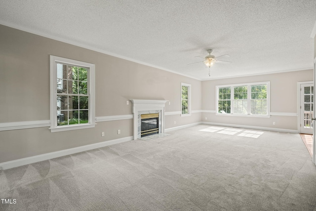 1005 Barmkin Pl, Knightdale, NC 27545 - unfurnished living room with crown molding, ceiling fan, a premium fireplace, a textured ceiling, and carpet