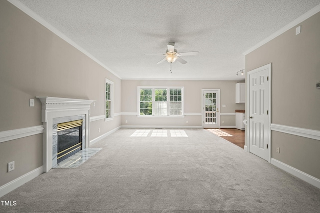 1005 Barmkin Pl, Knightdale, NC 27545 - unfurnished living room with ceiling fan, ornamental molding, a textured ceiling, a high end fireplace, and carpet flooring