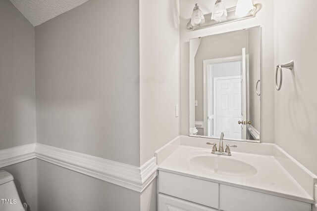 1005 Barmkin Pl, Knightdale, NC 27545 - bathroom featuring vanity, toilet, and a textured ceiling