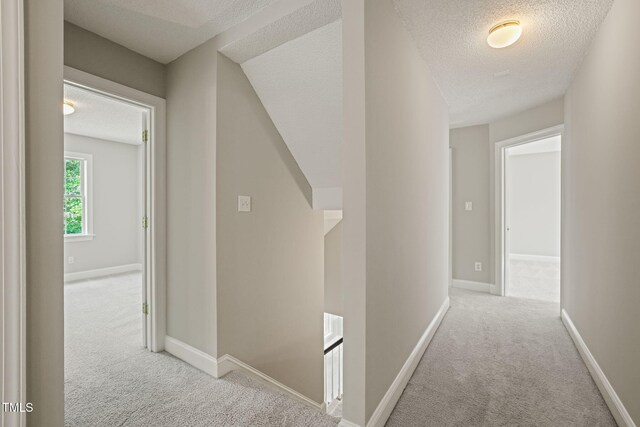 1005 Barmkin Pl, Knightdale, NC 27545 - hallway featuring carpet flooring, a textured ceiling, and baseboards