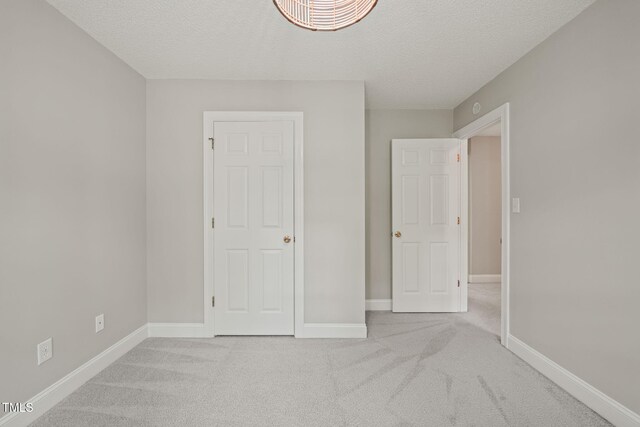 1005 Barmkin Pl, Knightdale, NC 27545 - unfurnished bedroom with a textured ceiling, carpet, and baseboards