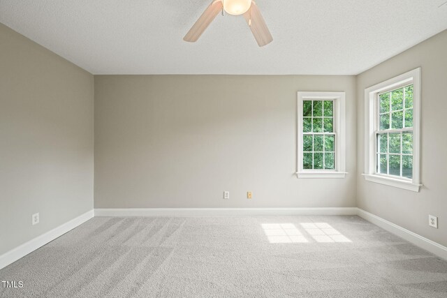 1005 Barmkin Pl, Knightdale, NC 27545 - empty room with carpet flooring, ceiling fan, baseboards, and a textured ceiling