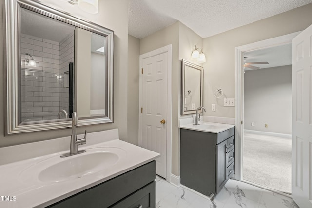 1005 Barmkin Pl, Knightdale, NC 27545 - full bath featuring a ceiling fan, two vanities, marble finish floors, a textured ceiling, and baseboards