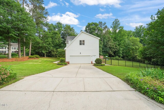 1005 Barmkin Pl, Knightdale, NC 27545 - view of home's exterior featuring a garage, driveway, and view of scattered trees