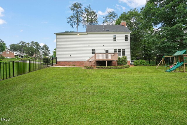 1005 Barmkin Pl, Knightdale, NC 27545 - rear view of house with a chimney, a playground, and a wooden deck