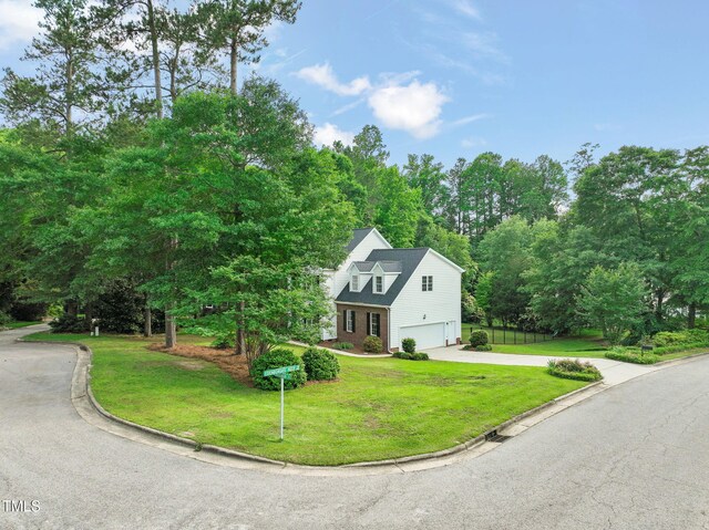 1005 Barmkin Pl, Knightdale, NC 27545 - view of front of home with an attached garage, concrete driveway, and view of wooded area