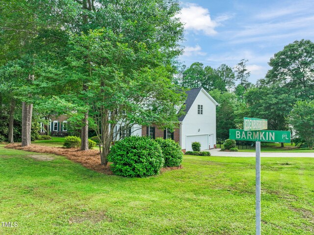 1005 Barmkin Pl, Knightdale, NC 27545 - view of side of home with a garage, driveway, and a lawn