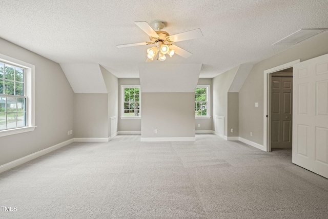 1005 Barmkin Pl, Knightdale, NC 27545 - bonus room featuring a textured ceiling, a ceiling fan, baseboards, and light carpet
