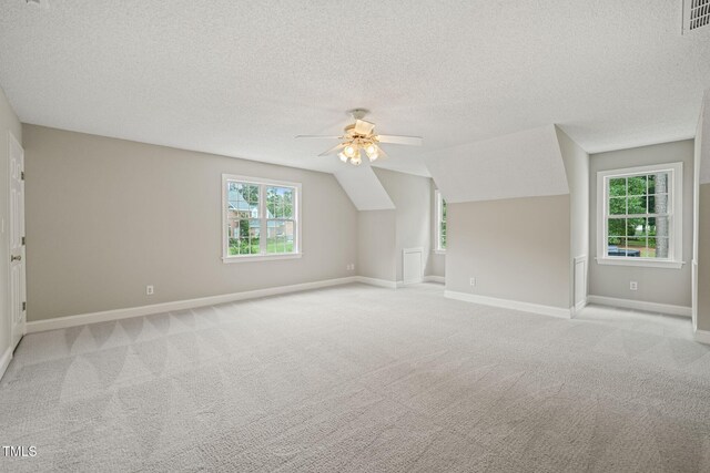 1005 Barmkin Pl, Knightdale, NC 27545 - bonus room with a textured ceiling, a ceiling fan, light carpet, baseboards, and plenty of natural light