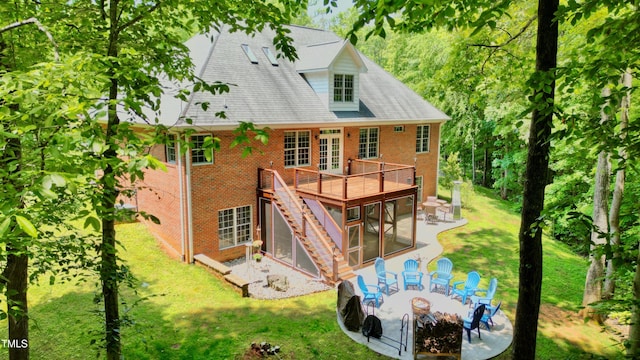 3750 Mebane Rogers Rd, Mebane, NC 27302 - rear view of property with an outdoor fire pit, brick siding, french doors, a patio area, and a wooden deck