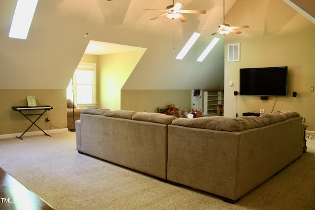 3750 Mebane Rogers Rd, Mebane, NC 27302 - carpeted living room featuring lofted ceiling, a skylight, a ceiling fan, and baseboards