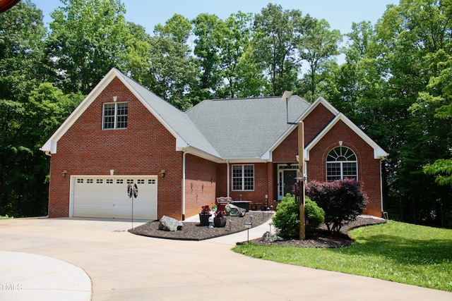 3750 Mebane Rogers Rd, Mebane, NC 27302 - view of front of house featuring concrete driveway, brick siding, an attached garage, and a front lawn