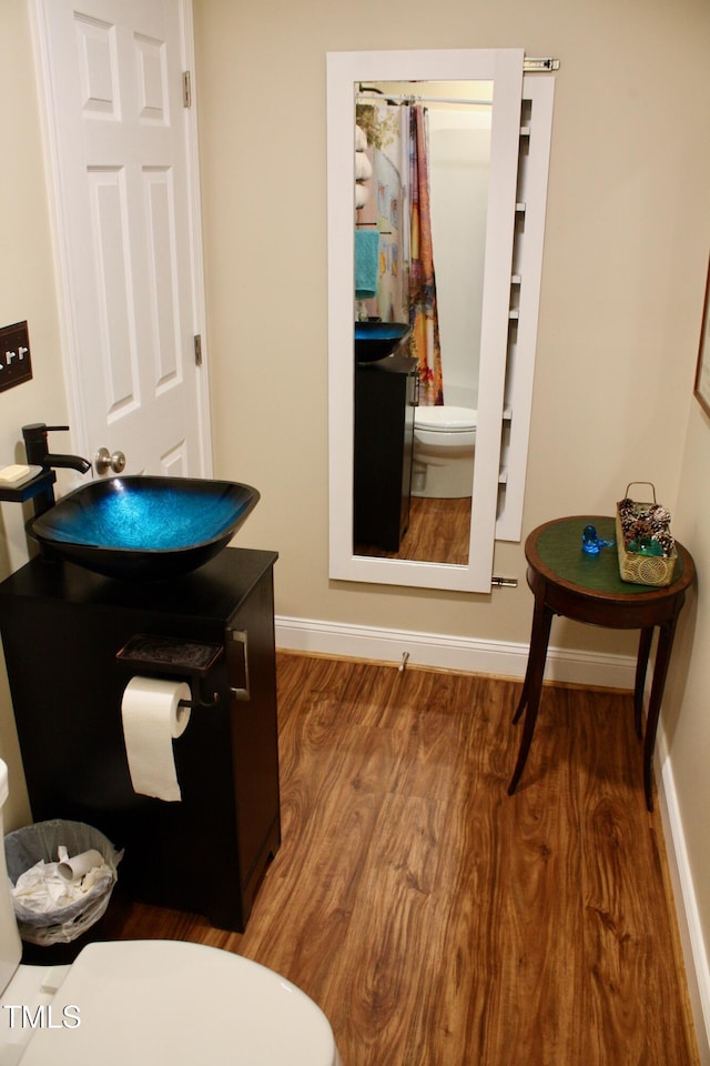 3750 Mebane Rogers Rd, Mebane, NC 27302 - bathroom featuring toilet, wood finished floors, baseboards, curtained shower, and vanity