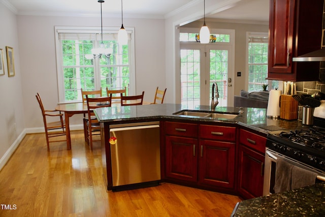 3750 Mebane Rogers Rd, Mebane, NC 27302 - kitchen with stainless steel appliances, a sink, reddish brown cabinets, healthy amount of natural light, and ornamental molding