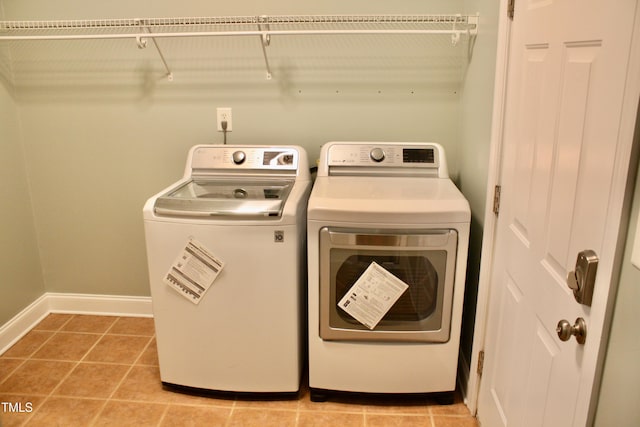 3750 Mebane Rogers Rd, Mebane, NC 27302 - laundry room with washer and clothes dryer, baseboards, and light tile patterned flooring