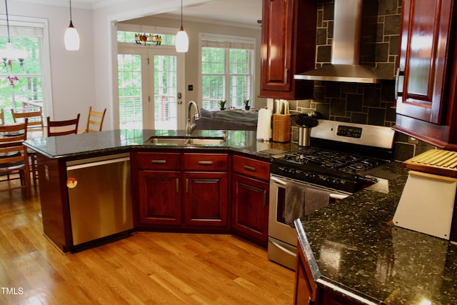 3750 Mebane Rogers Rd, Mebane, NC 27302 - kitchen featuring appliances with stainless steel finishes, a sink, dark brown cabinets, wall chimney range hood, and crown molding
