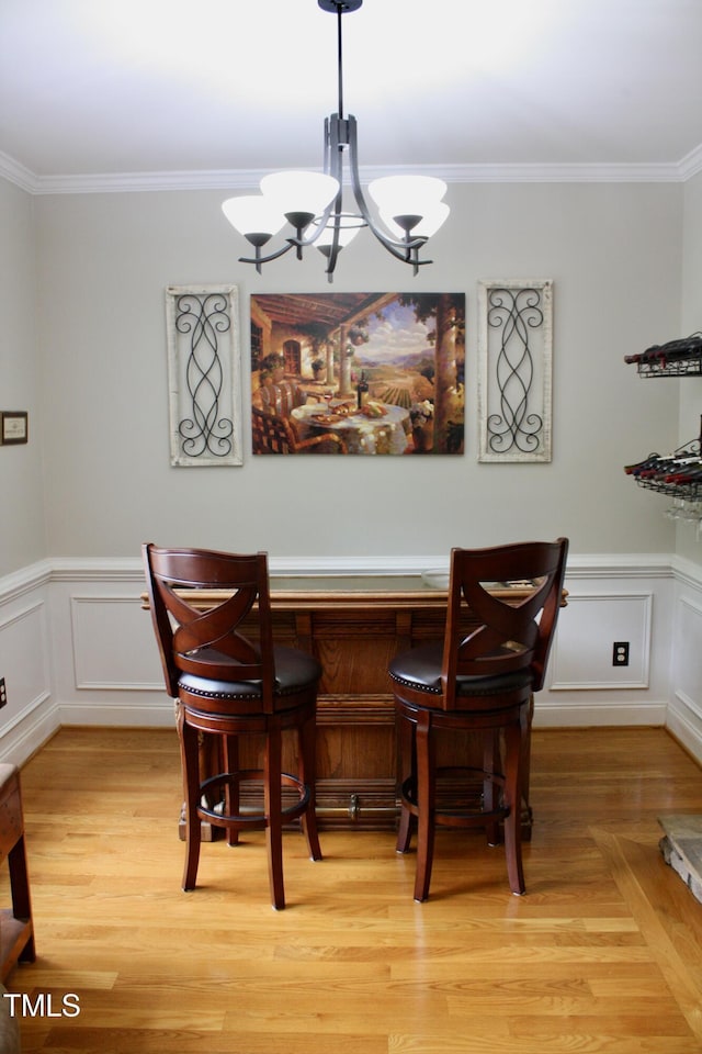 3750 Mebane Rogers Rd, Mebane, NC 27302 - dining space with ornamental molding, a chandelier, a decorative wall, a dry bar, and wainscoting