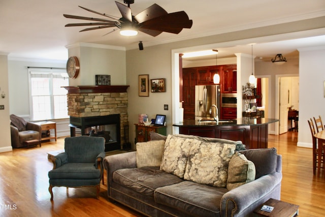 3750 Mebane Rogers Rd, Mebane, NC 27302 - living area featuring a ceiling fan, ornamental molding, light wood finished floors, a fireplace, and baseboards