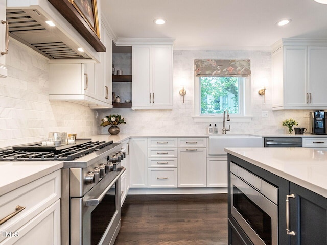 2303 Byrd St, Raleigh, NC 27608 - kitchen featuring appliances with stainless steel finishes, custom range hood, a sink, light countertops, and decorative backsplash