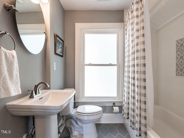 2303 Byrd St, Raleigh, NC 27608 - full bathroom featuring toilet, plenty of natural light, tile patterned floors, and shower / bath combo