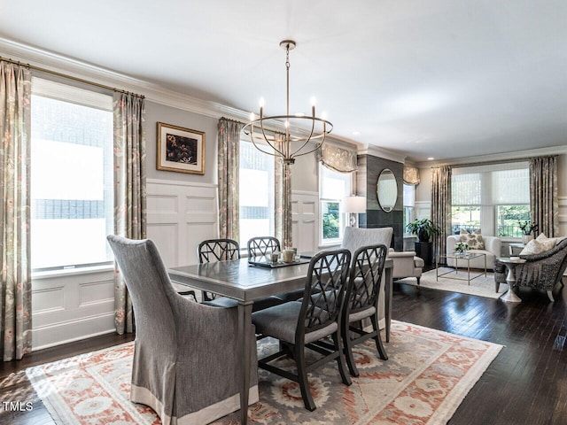 2303 Byrd St, Raleigh, NC 27608 - dining area featuring a decorative wall, a chandelier, crown molding, wood finished floors, and a wainscoted wall