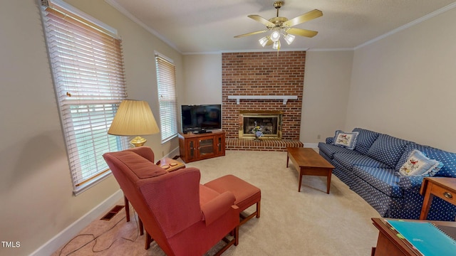 carpeted living room with a ceiling fan, ornamental molding, baseboards, and a brick fireplace