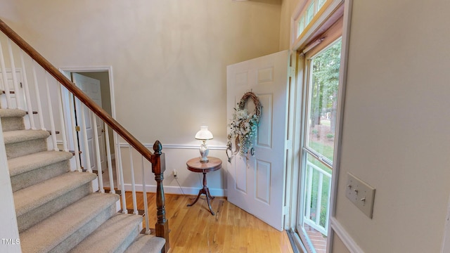 entrance foyer featuring stairs, light wood-style flooring, and baseboards