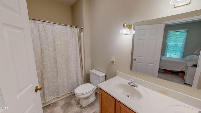 bathroom featuring vanity, toilet, and a shower with shower curtain