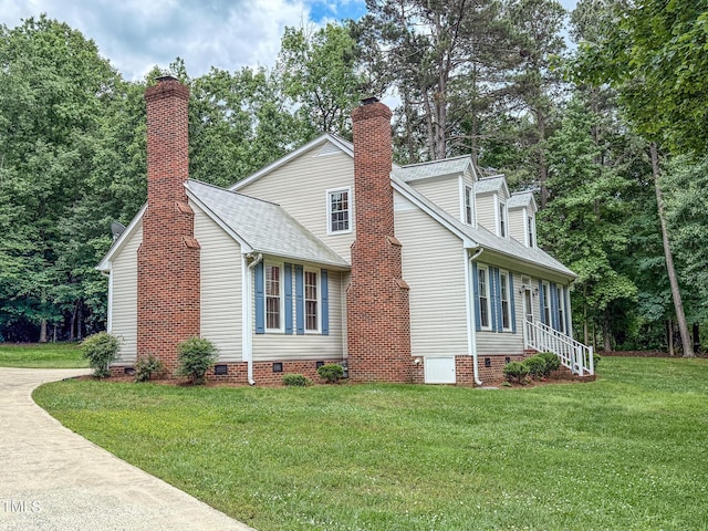view of home's exterior featuring crawl space, a lawn, a shingled roof, and a chimney