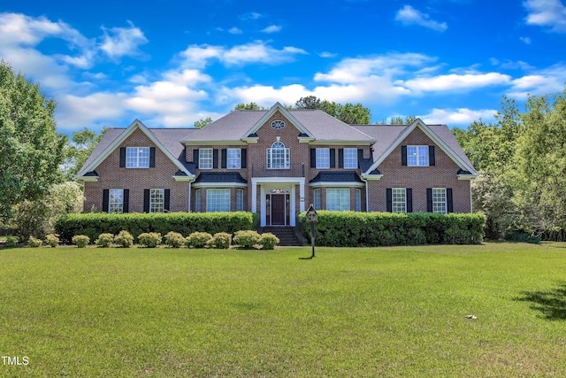 107 Stargrass Ave, Clayton, NC 27527 - colonial-style house featuring a front yard and brick siding