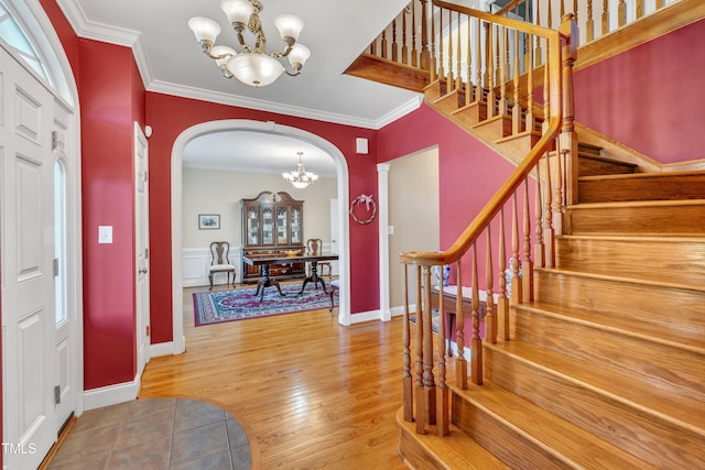107 Stargrass Ave, Clayton, NC 27527 - foyer with a chandelier, arched walkways, wood finished floors, ornamental molding, and stairway