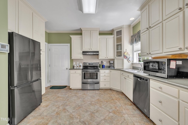 107 Stargrass Ave, Clayton, NC 27527 - kitchen with appliances with stainless steel finishes, a sink, under cabinet range hood, crown molding, and decorative backsplash
